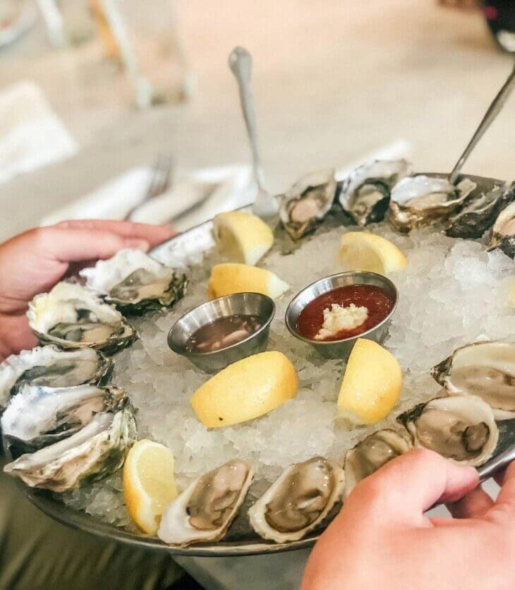 clams and oysters with lemons on ice