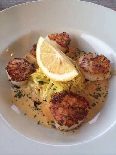 grilled scallops served with sauce and lemon