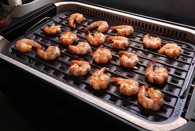 shrimp laid out on grill ready to cook
